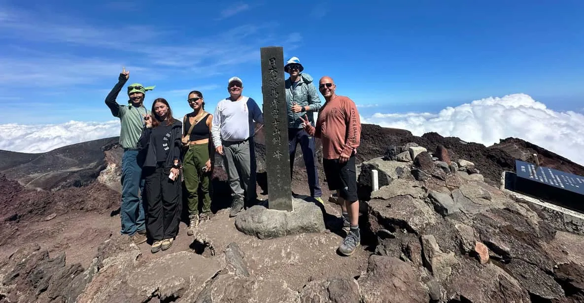 A small group on a single-day Mount Fuji climbing tour ascending the daytime trail toward the summit in Japan
